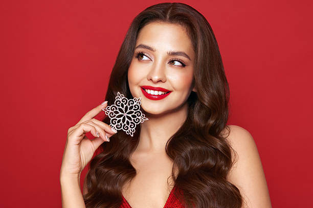istock Beautiful young woman with glowing snowflake 2251121791