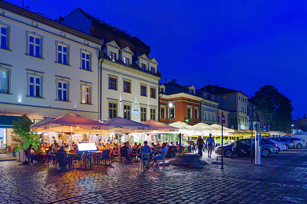 Krakow, Poland - September 22, 2025: Evening street scene, with locals and visitors, in the Kazimierz quarter of Krakow, Poland