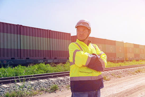 istock Asian architect engineer wearing safety uniform surveying and working at building structure checking blueprints construction site road general job details business concept architecture street 2251123496