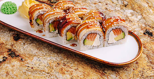 istock Delicious sushi rolls served on a marble tabletop garnished with wasabi 2251124652