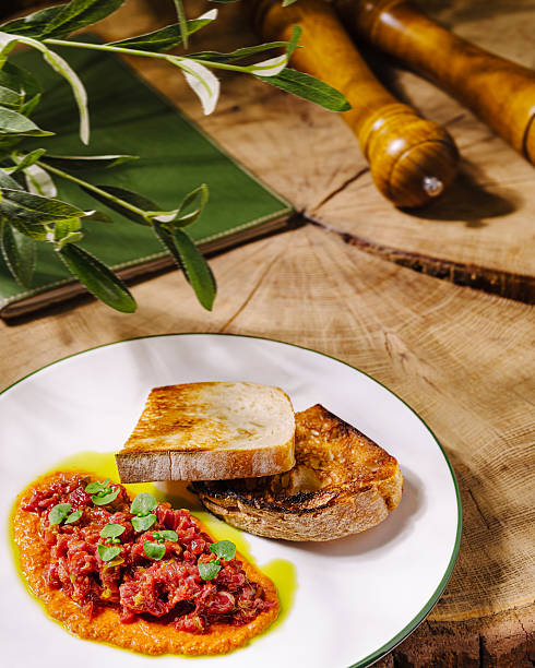 istock Freshly prepared dish with bread and sauce on rustic wooden table 2251124788