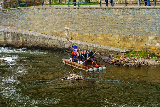 White Water Canoeing on the river dee in the centre of Llangollen, UK  People can be seen in the canoe.