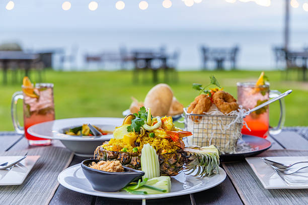 istock Tropical outdoor dining with pineapple fried rice, calamari, and 2251125612