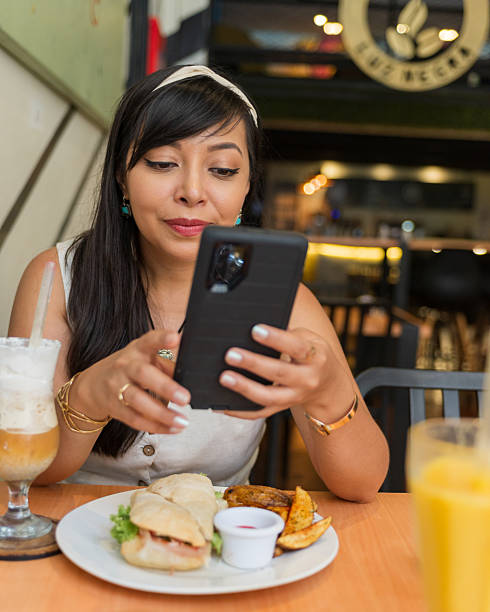 istock Casual Lifestyle Woman Using Smartphone During Lunch at Restaurant 2251126053