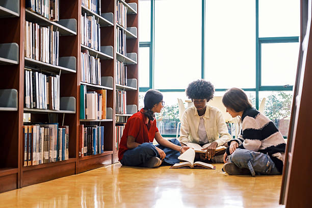 Tutor, girl and library stairs with study for information, learning or knowledge for academic woman. Book session, student development and education with teacher, scholarship and walking people