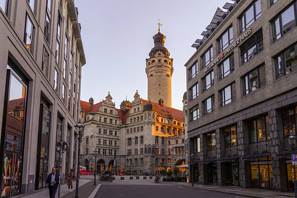 Leipzig, Germany - September 29, 2025: Sunset street view with the New Town Hall, locals and visitors, in Leipzig, Saxony, Germany