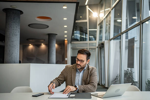 istock Businessman signing document in modern office 2251127297