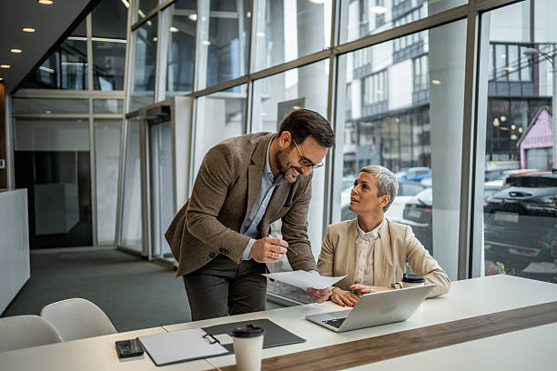 istock Business colleagues collaborating on documents in modern office 2251127477