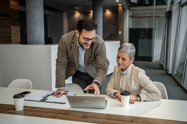 istock Business colleagues collaborating on laptop in modern office 2251127503