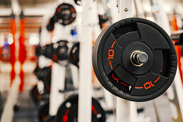 istock Gym barbell weight plate on a squat rack 2251127950