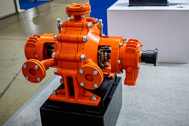istock Bright orange industrial pump or gearbox with visible internal gears, displayed in a clean environment. Represents heavy machinery, engineering, and manufacturing technology. 2251131175