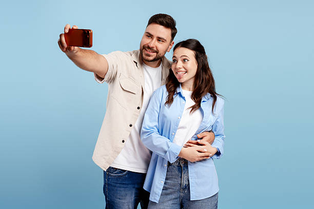 istock Young couple taking a playful selfie on Valentine's Day 2251132874