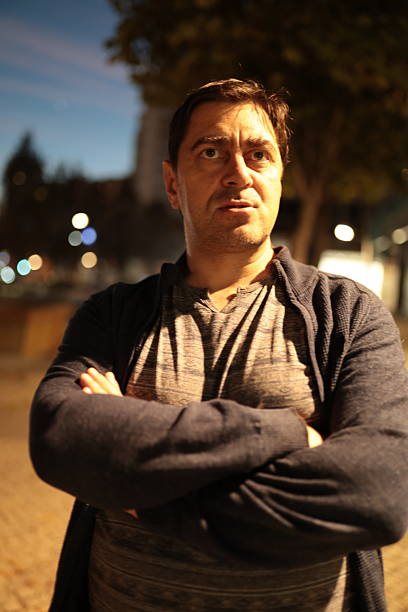 istock Man looking surprised with arms crossed at night 2251133042