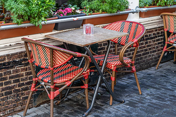 istock Empty table and chairs at a street cafe in Amsterdam 2251138658