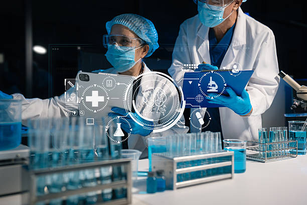 istock Team of biochemical research scientists working with a microscope for vaccine development. 2251144104