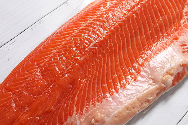 istock Fresh raw salmon fish piece over wooden board 2251149172