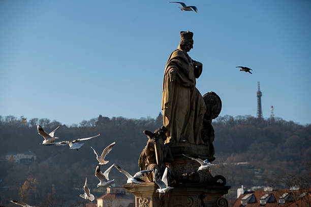 Prague, Czech Republic - May 14, 2018:  People walk on the Charles bridge across Vltava River in the historic district  of Praha