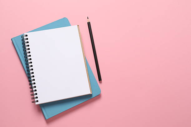 istock Flat lay with pencil and notebook on pink background, top view 2251150224