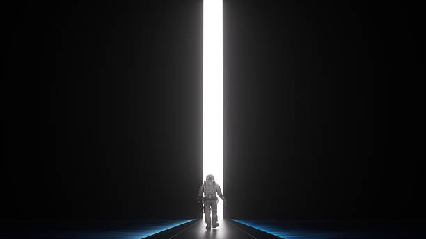 istock Astronaut walking toward glowing doorway in dark space 2251151650