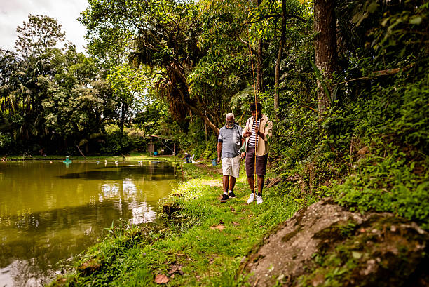 istock Father and son walking by the lake to fish 2251152616