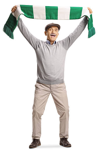 istock Happy elderly men cheering with a scarf 2251154604