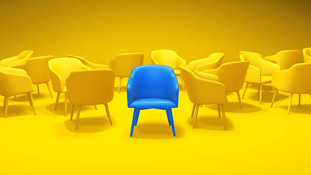 istock 3D Standout Blue Chair Among a Yellow Crowd 2251155827