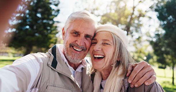 istock Portrait, selfie or old couple in park with hug for connection, commitment or healthy relationship. Happy people, elderly man or senior woman outdoor for embrace, love photography or bonding together 2251159444