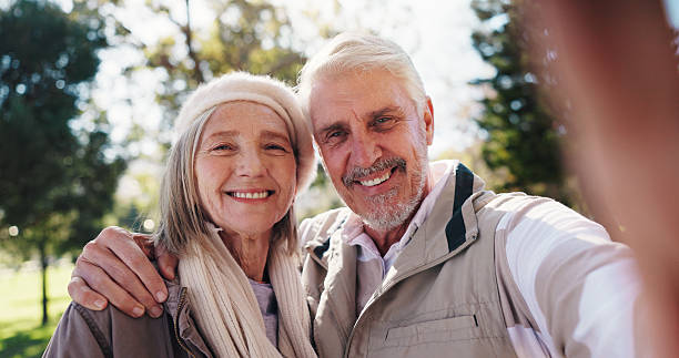 istock Portrait, selfie and old couple in park with smile for connection, commitment or healthy relationship. Married people, elderly man and senior woman outdoor for love, photography and bonding together. 2251159449