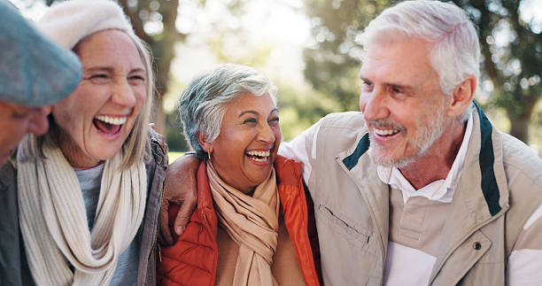 istock Group, hug and laughing with old people in park for retirement, bonding or support. Happiness, trekking and social reunion with couple of senior friends outdoor for health, embrace and joke together 2251159573
