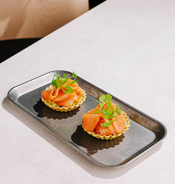 istock Delicious seafood tartlets served on a sleek metallic tray in a modern setting 2251160737