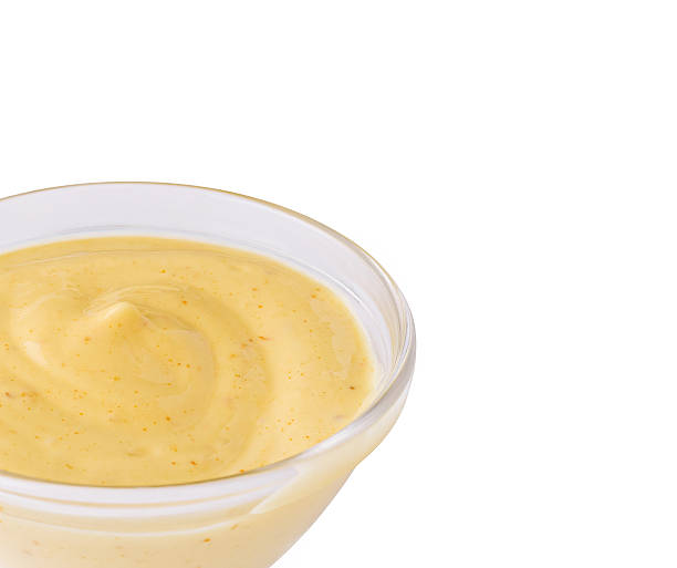 istock Mustard dressing in a clear bowl on a white background 2251160773