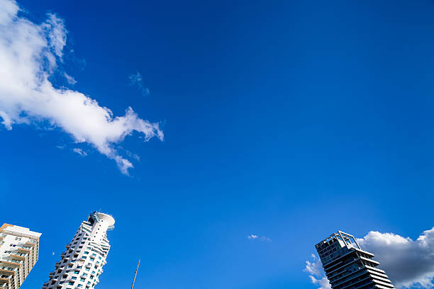 Futuristic architecture against a blue sky in Tel Aviv, Israel.