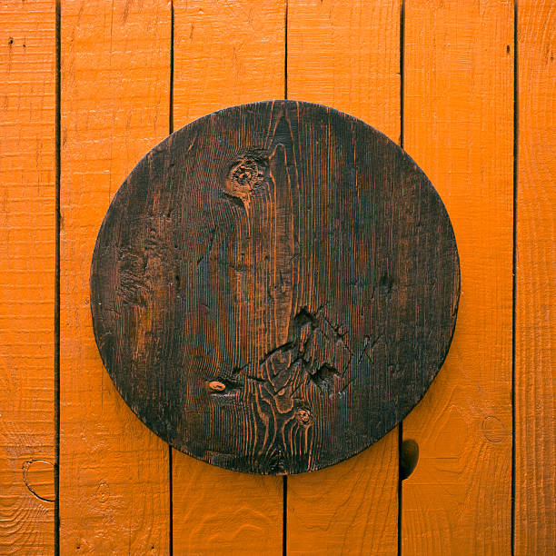 empty grunge, wooden plate on old table, orange background