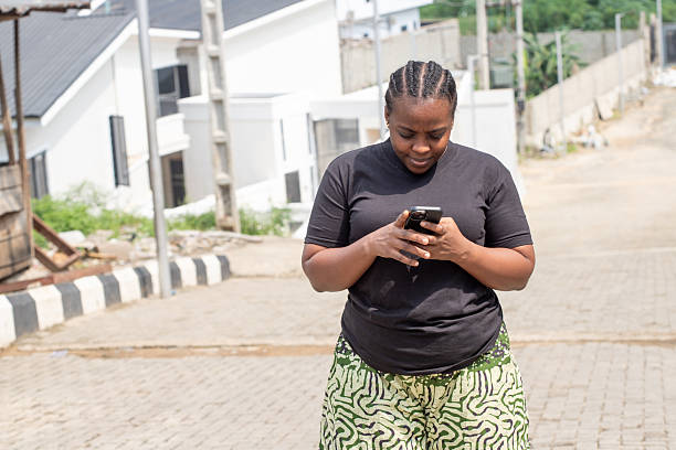 istock Young African Woman Using Her Smartphone in a Residential Setting 2251162952