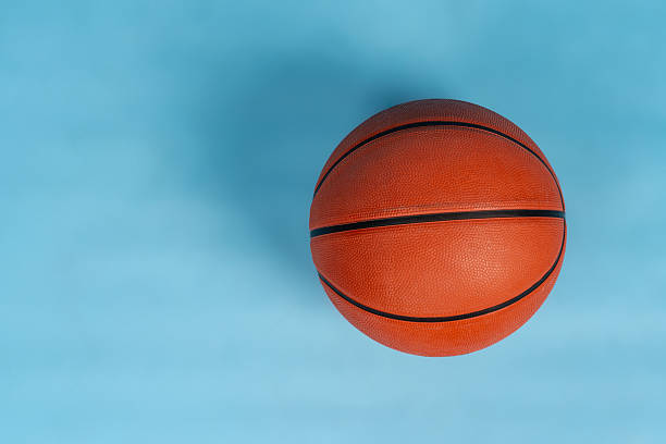 istock Ball for basket ball on an orange background 2251168340
