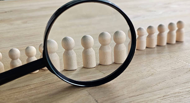 istock Talent search and selection concept. A magnifying glass and candidates symbolize the process of talent acquisition, hiring, and selection. HR, personnel management 2251168854