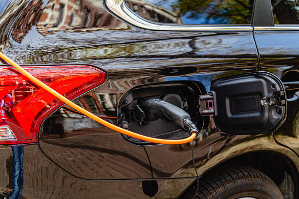 istock Electric vehicle charging station with orange cable in urban setting 2251168859