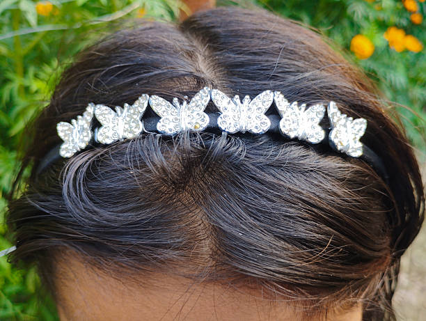 istock Dark Hair Adorned with a Sparkling Silver Butterfly Headband Accessory 2251168930