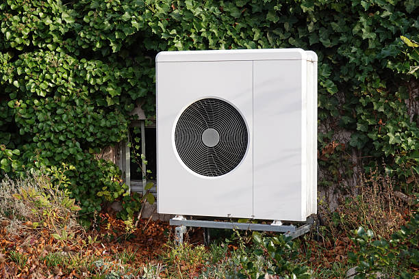 istock air source heat pump in front yard for heating and cooling residential building 2251170566