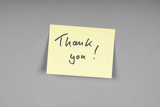 istock yellow adhesive note with handwritten thank you message 2251170599