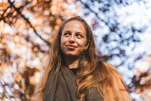 istock Joyful Woman Immersed in Autumn Landscape 2251170721