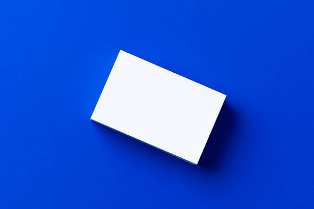 istock Blank white businesscards on classic blue background 2251174013