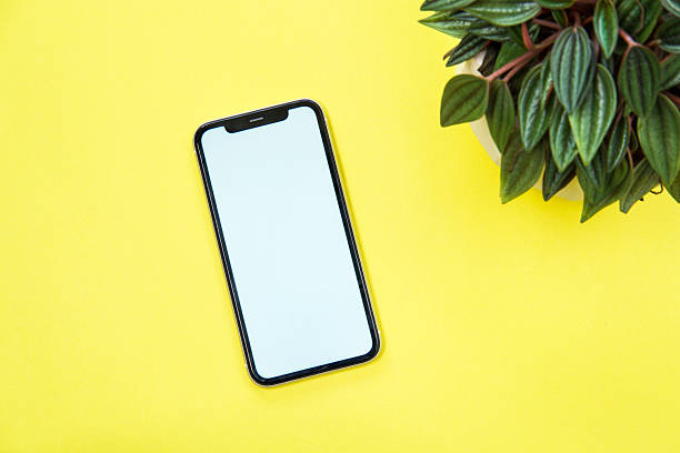 istock A smartphone with a blank white screen on a yellow background. 2251175935