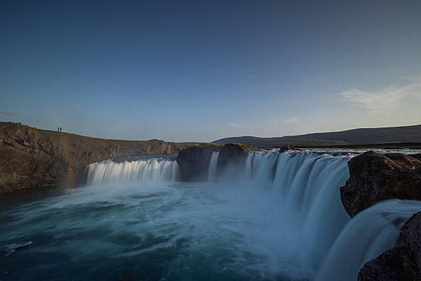 A wide, majestic shot of the Goðafoss waterfall (the \
