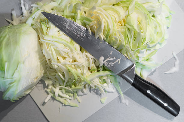 istock a cutting board on the kitchen table, sliced white cabbage and a kitchen knife 2251180536