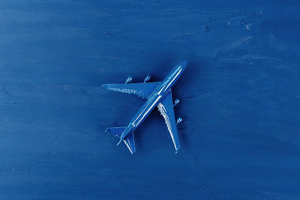istock Toy plane on classic blue background, top view 2251180680