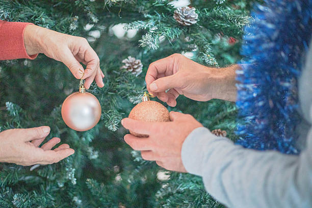 istock human hands placing Christmas decorations on a Christmas tree 2251183016