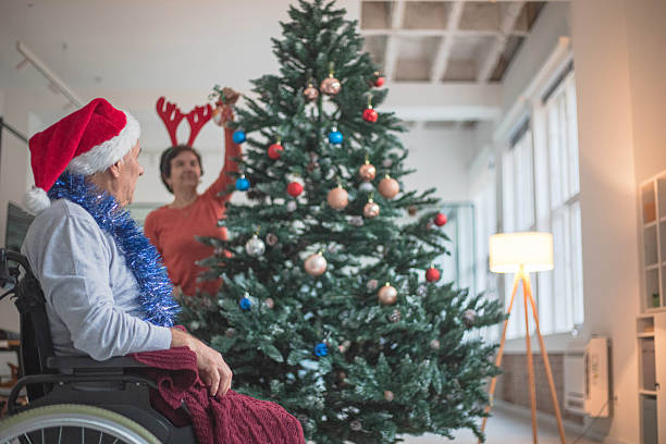 istock Decorating a Christmas tree in a nursing home, creative socializing 2251183184