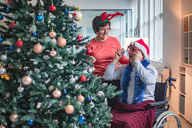 istock Decorating a Christmas tree in a nursing home, creative socializing 2251183425