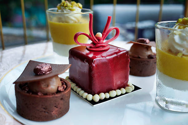 istock Luxury afternoon tea petit set dessert platter featuring red mirror glaze mousse cake and chocolate tartlets. 2251185397